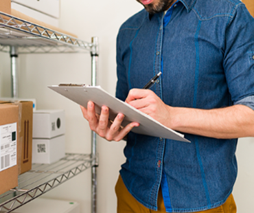 Man with clipboard stock checking inventory