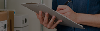 Man with clipboard stock checking inventory